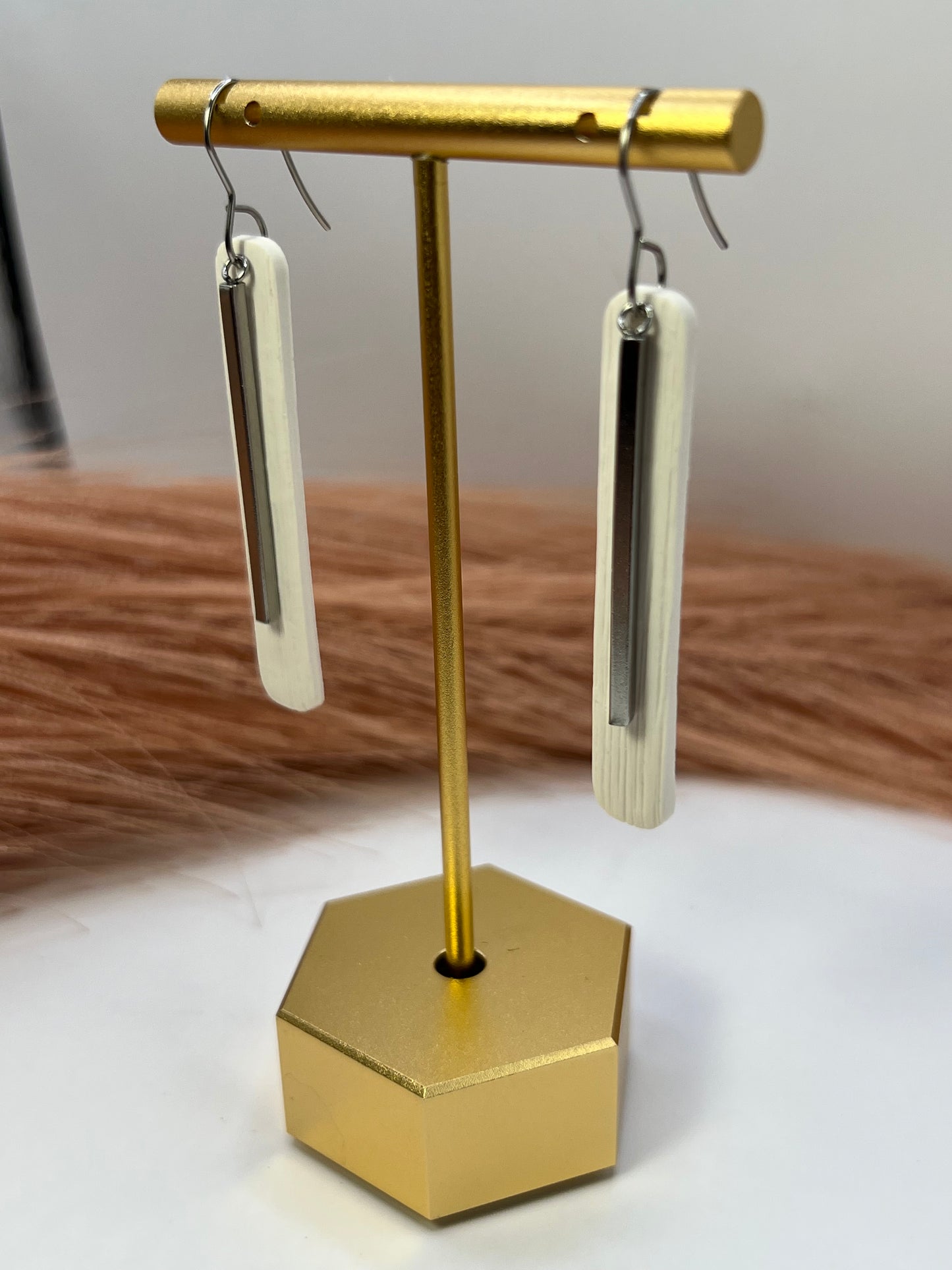 White elongated dangles