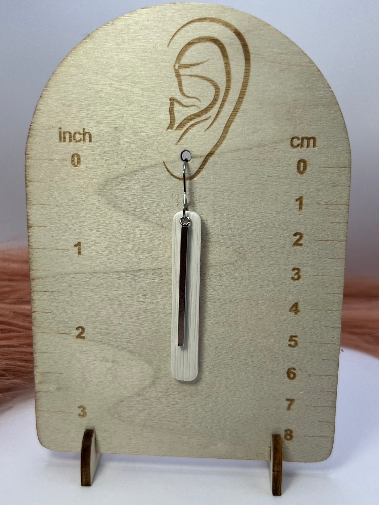 White elongated dangles