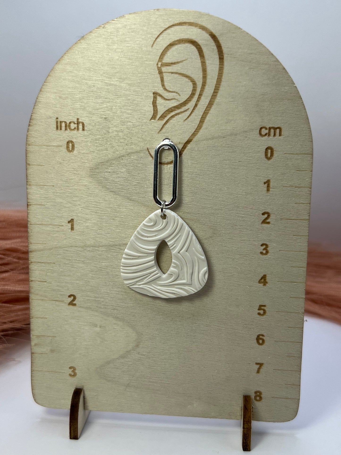 White imprinted swirl dangles