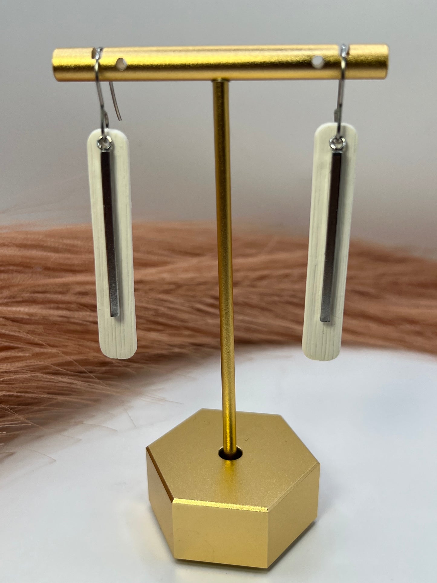 White elongated dangles