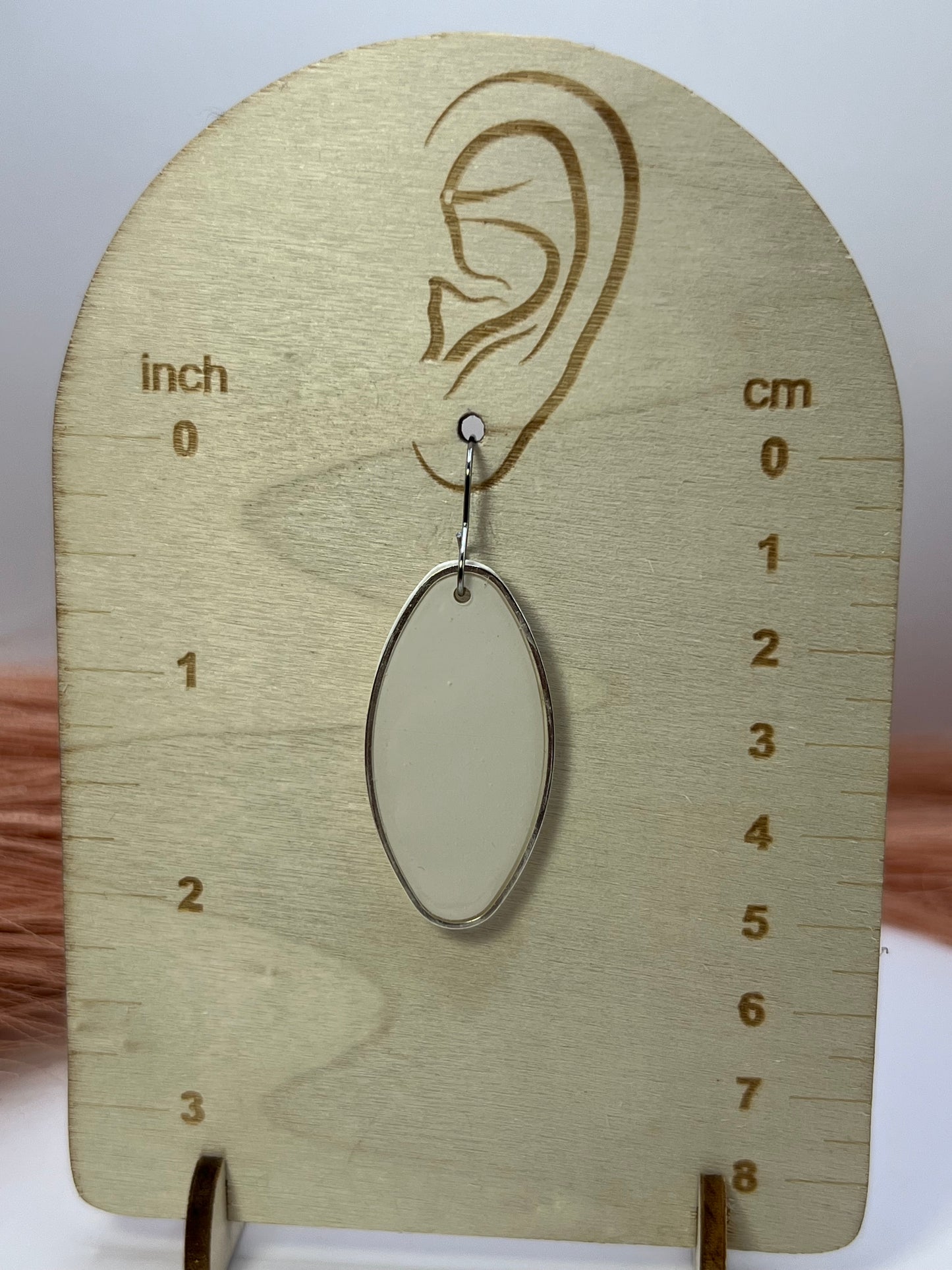 White oval silver outlined dangles