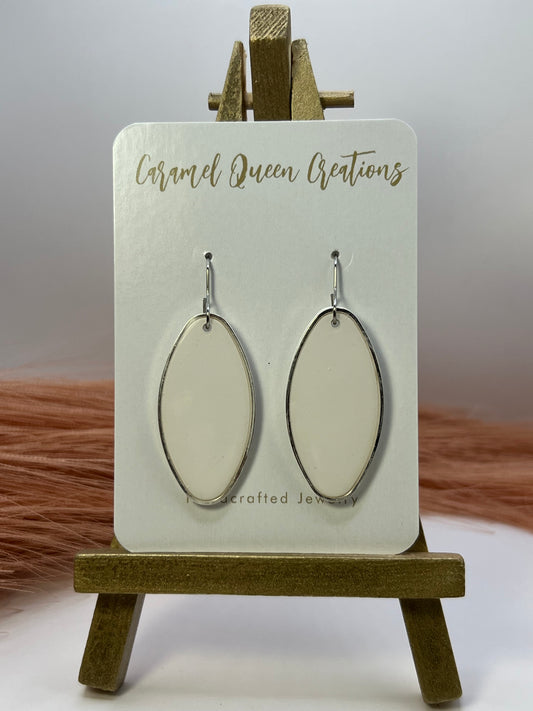 White oval silver outlined dangles