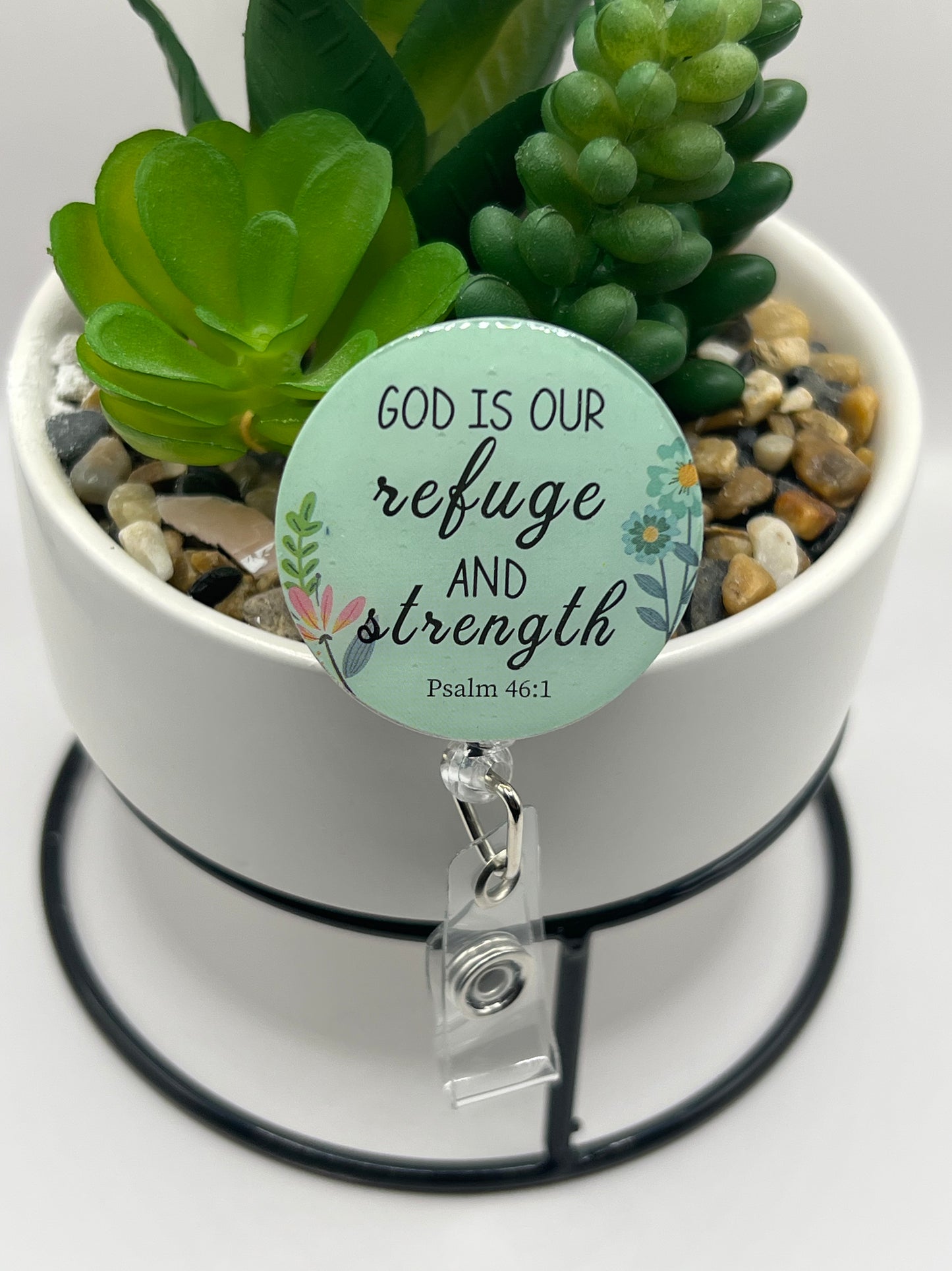 “God is our refuge” badge reel